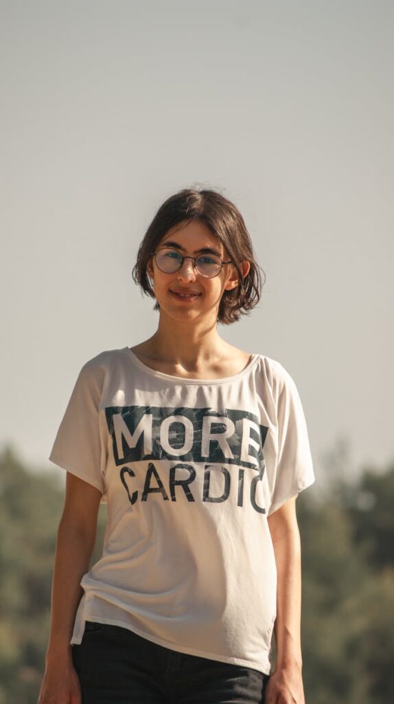 Woman in White Crew Neck T-shirt Wearing Eyeglasses